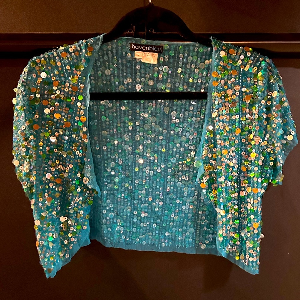 Sparkly blue and shortsleeved, this is a great addition to a dress or top!